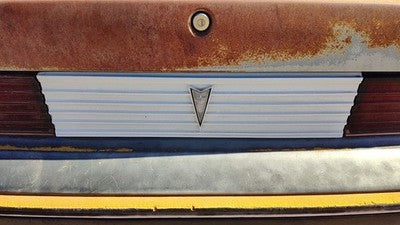 85-87 Pontiac Sunbird License Plate Trim Surround Panel 2Dr Tail Trunk Finish