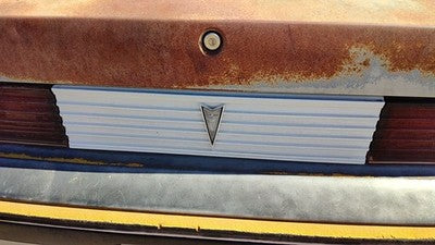 85-87 Pontiac Sunbird License Plate Trim Surround Panel 2Dr Tail Trunk Finish