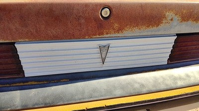 85-87 Pontiac Sunbird License Plate Trim Surround Panel 2Dr Tail Trunk Finish